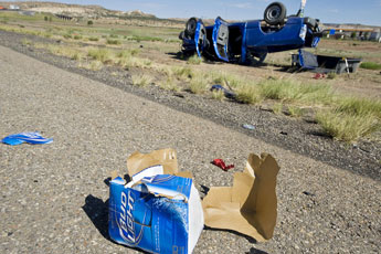 A tattered beer case lies near an overturned pickup at the scene of a rollover and double fatality on westbound Interstate Highway 40 near exit 26 Saturday morning. © 2011 Gallup Independent / Cable Hoover 